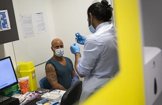A war veteran having a vaccine administered