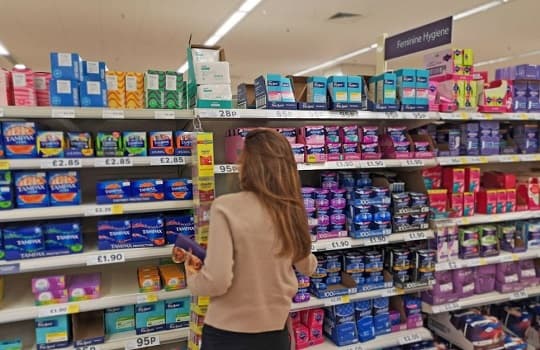 A woman buying tampons