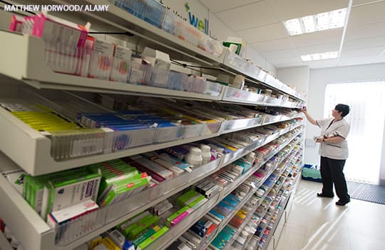 Pharmacist putting medicine on a shelf