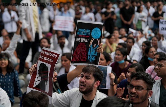 Medical professionals and students shout slogans as they protest against the rape and murder of a trainee doctor