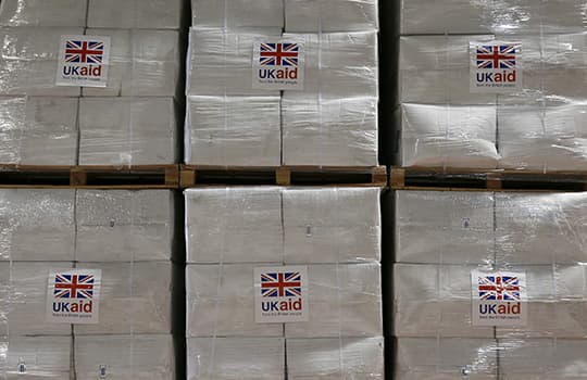 G7AHD6 Boxes containing kitchen sets are stored at a UK aid Disaster Response Centre at Kemble Airport, Wiltshire.