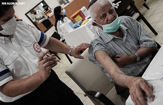 A man receives his covid booster vaccine in Israel