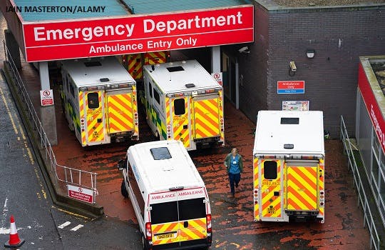 Ambulances wait to unload patients at the A&E department at Glasgow Royal Infirmary in Glasgow
