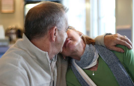 Two older people kissing