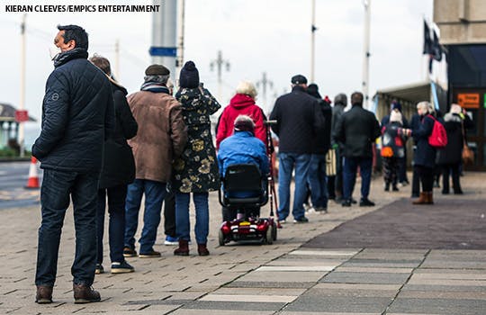 People queue to receive their Covid-19 vaccine at a vaccination centre inside the Brighton Centre, Sussex, as the UK continues in a third lockdown due to the coronavirus pandemic. Picture date: Tuesday February 9, 2021.