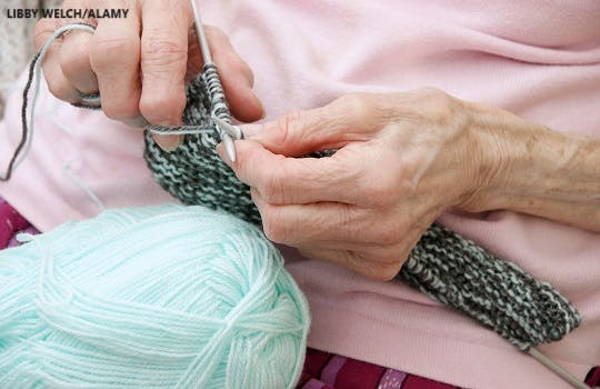 A woman with arthritis knitting