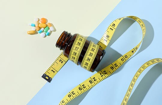 Pill bottle and measuring tape