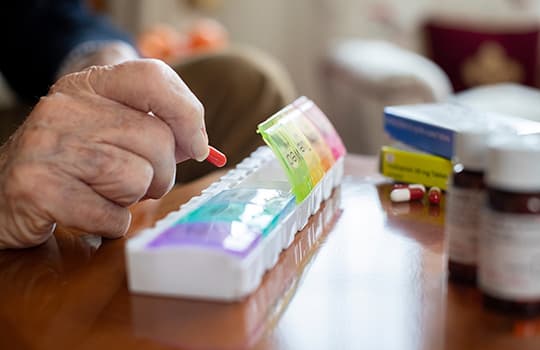 Elderly man taking medication